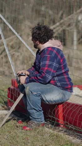 man sitting outdoors using his phone