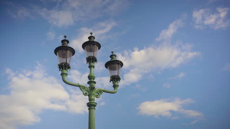 a beautiful copper green classic lamppost adorned with tree lights