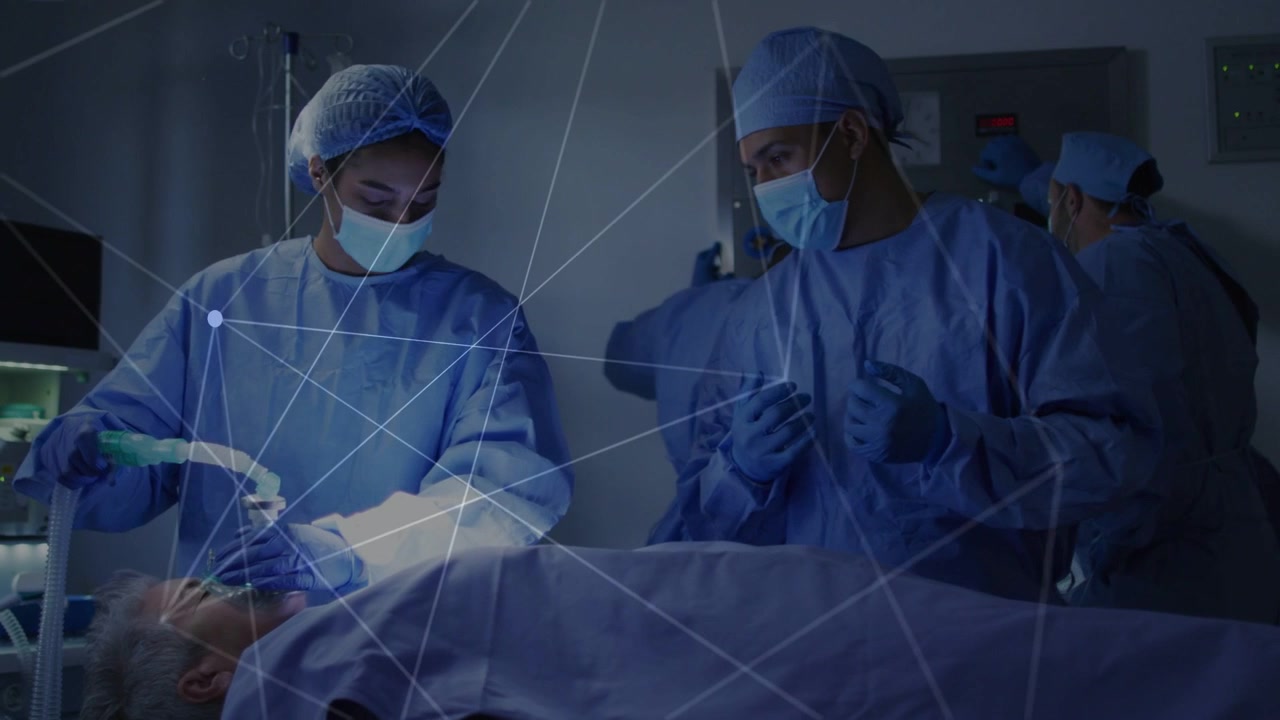 Left clinician placing mask, securing airway for surgery, assistant monitoring, overlay appearing