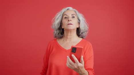 Excited Senior Woman Using Smartphone