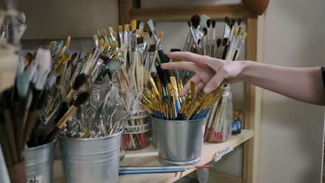 artist choosing paintbrushes