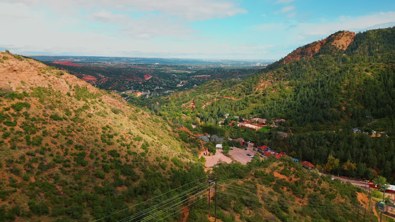 Approaching the group of houses located among the mountains. Drone flight over the panorama of Bentonite Hills, Utah, USA
