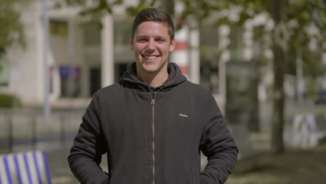 Handsome-happy-man-looking-at-camera-outdoor