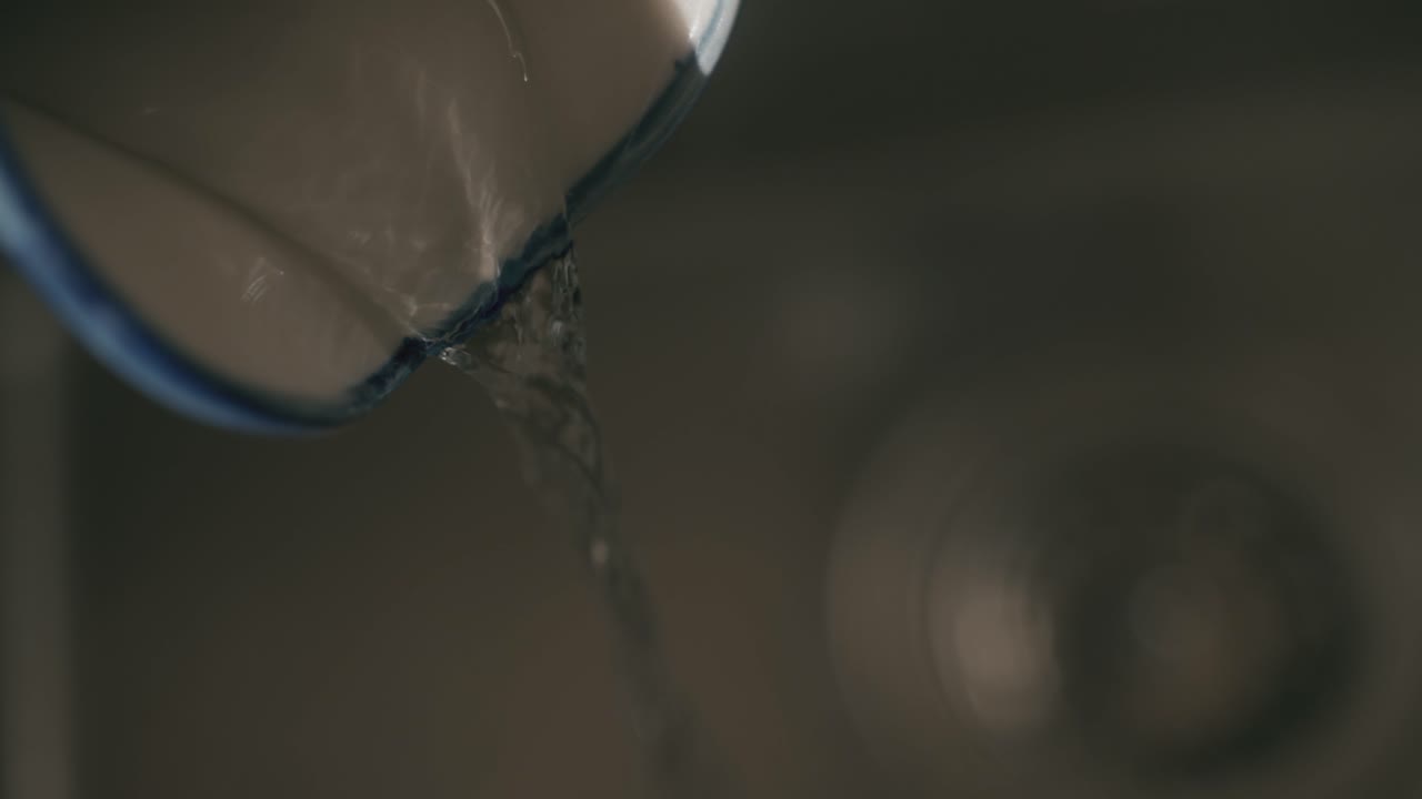 Water pouring from a jug in slow motion