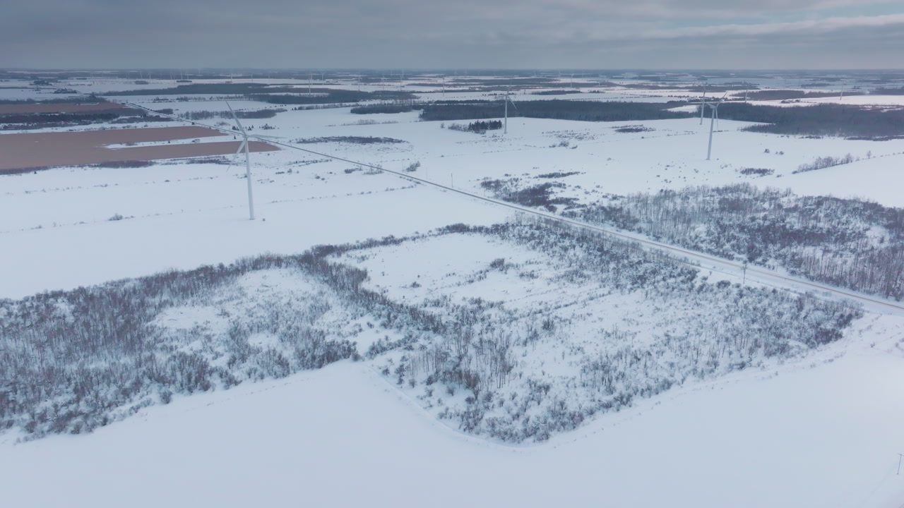 Snowy wind turbines in winter Shelburne, Ontario, serene landscape