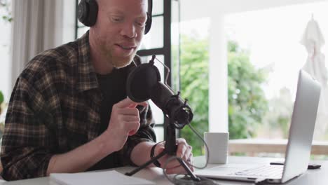 Happy-albino-african-american-man-with-dreadlocks-making-podcast