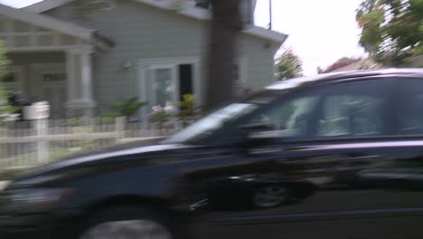 a car travels along a street in santa monica california as seen through the side window 7