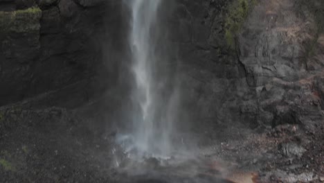 Drone-tilts-up-to-reveal-the-third-tallest-waterfall,-Gocta-in-Peru