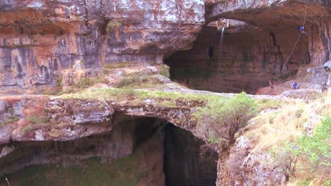 a waterfall and cave attracts repellers and adventurers in the hills of lebanon  3