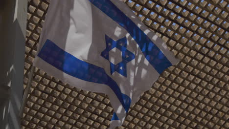 israeli flag flaps vigorously in the wind