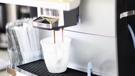 sequence of coffee being dispensed into a cup