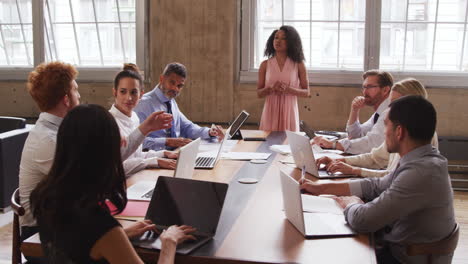 Black-female-boss-answering-questions-at-a-business-meeting