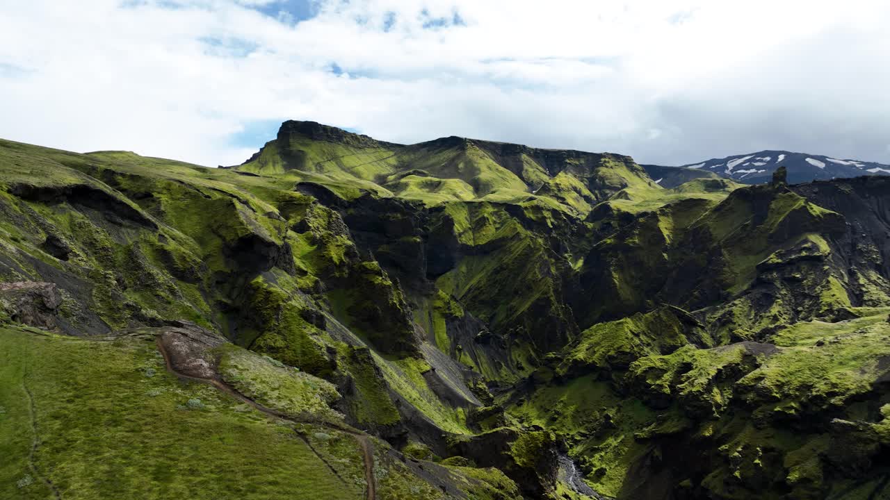Hiker on the Fimmvörðuháls trail and the nature around, Drone orbit, Iceland
