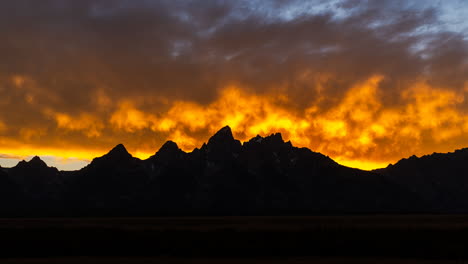 dramatic fiery sunset over mountain silhouettes