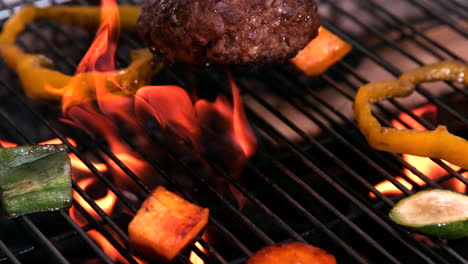 burger falling onto flaming barbecue