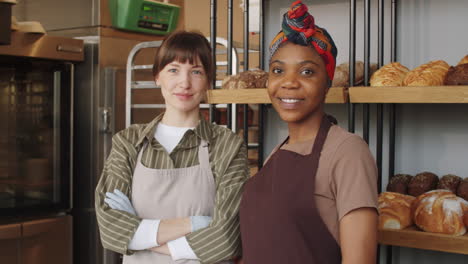 portrait of two multiethnic women at work in bakery