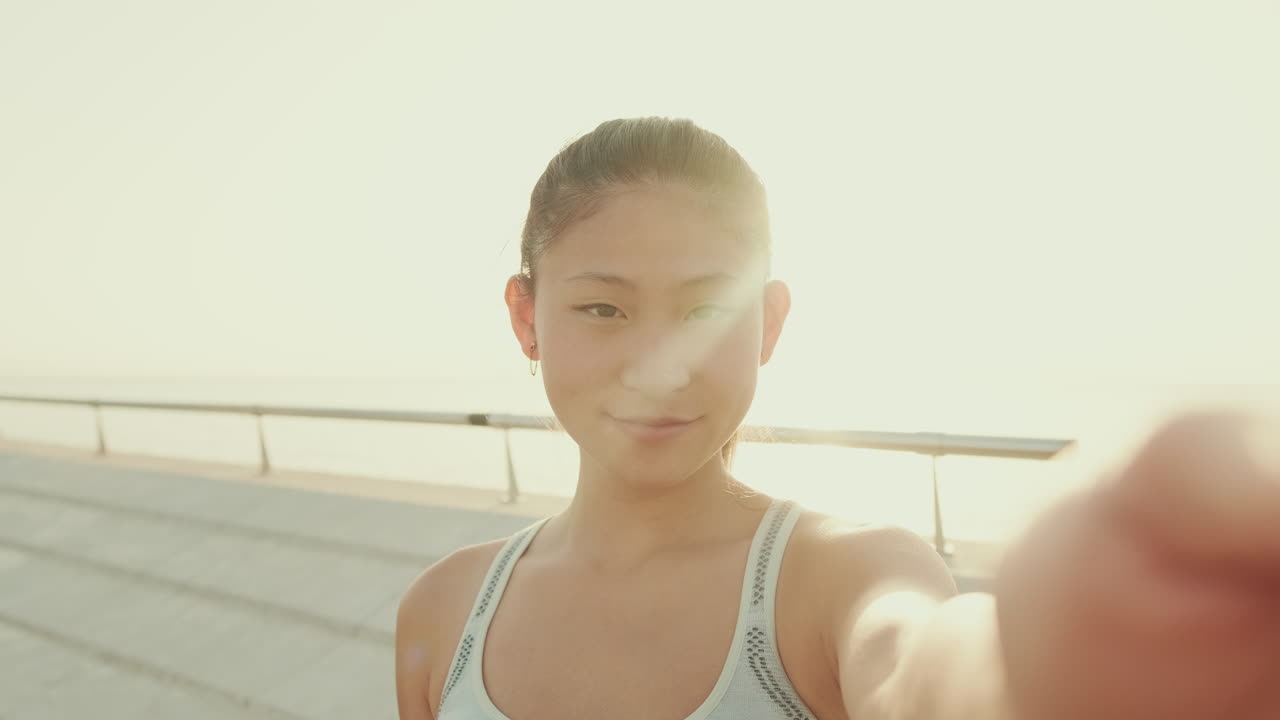 Young Asian woman taking a selfie outdoors