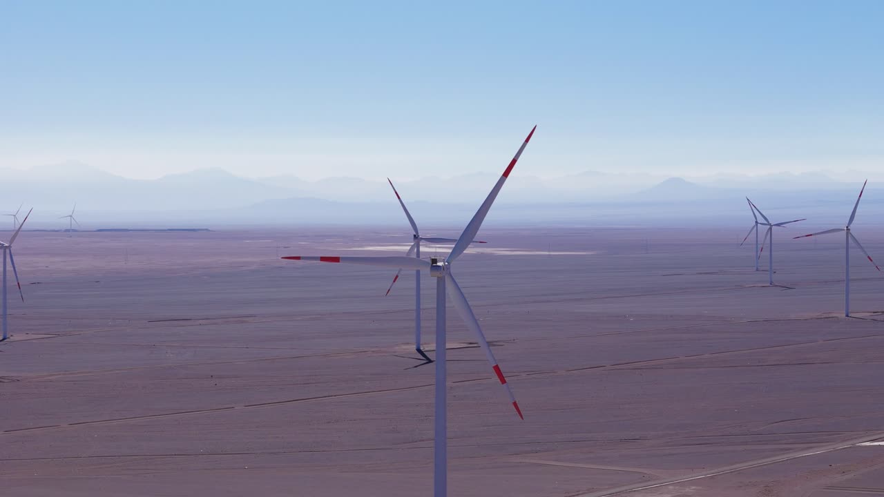 Aerial view of wind power turbines, rainy day in the southwestern deserts of chile