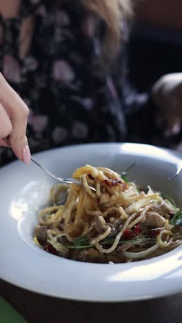 woman eating pasta