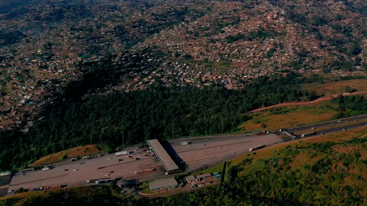 Aerial hyperlapse moving over busy highway toll collection point