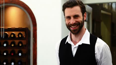 male waiter smiling in restaurant 4k