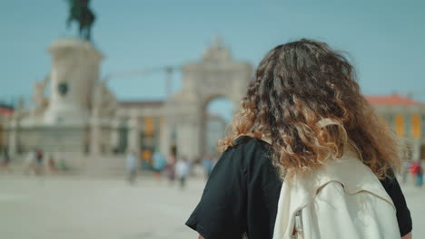 woman exploring lisbon's plaza