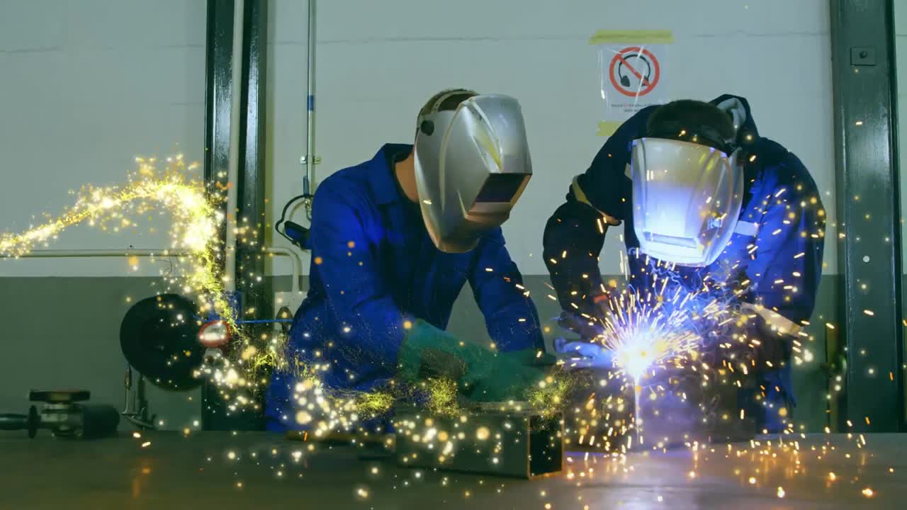 Animation of glowing shooting star over male engineers welding