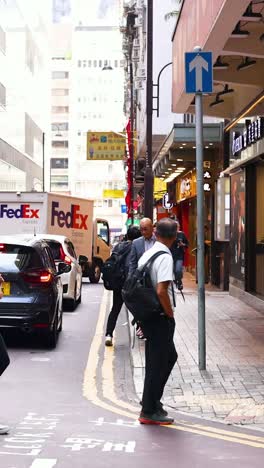 pedestrians and vehicles navigate a bustling street