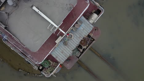 a small general cargo ship on repairs docked in a shipyard