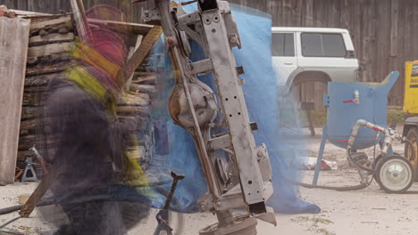 motion timelapse of a worker sandblasting vehicular frame outdoor