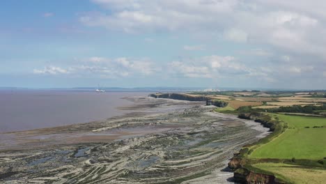 drone shot while moving forward over kilve beach in north devon, uk