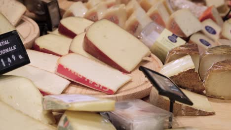 buying cheese at the market.  picking food at the grocery store. retail product. fresh gastronomy.