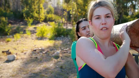 trainer assisting woman in exercising