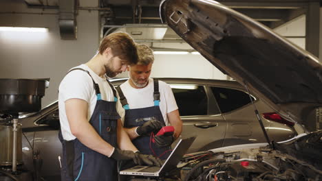 car repair technicians inspecting engine