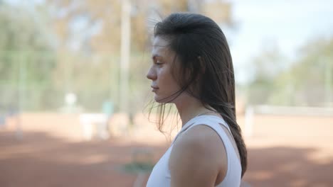 beautiful tennis girl practicing serve on outdoor court