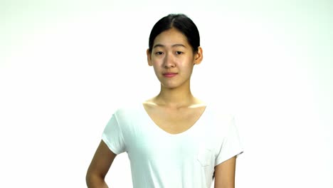 young asian 20s woman black wrapped hair without cosmetic make up or fresh face look in t-shirt express emotion on white background for viral clip casting or advertising