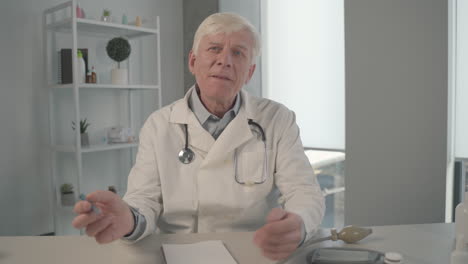 a grey haired, middle aged doctor on an online medical consultation 1