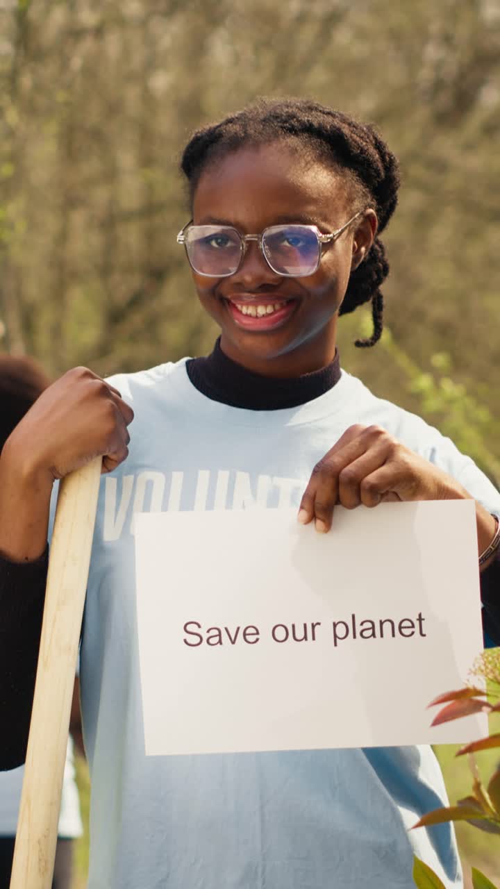 Young Woman Volunteer Holding 'Save Our Planet' Sign and Shovel
