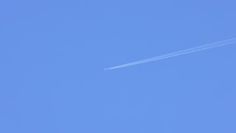 airplane leaving contrail in clear blue sky