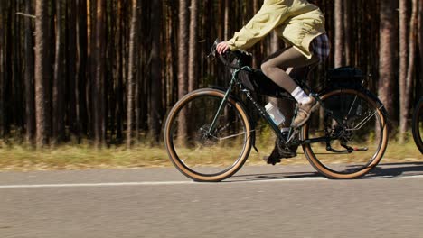 two women cycling through a forest