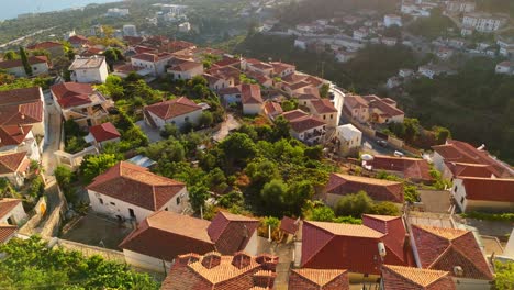 ancient town of dhermi with traditional red-tiled roofs nestled in lush mountains