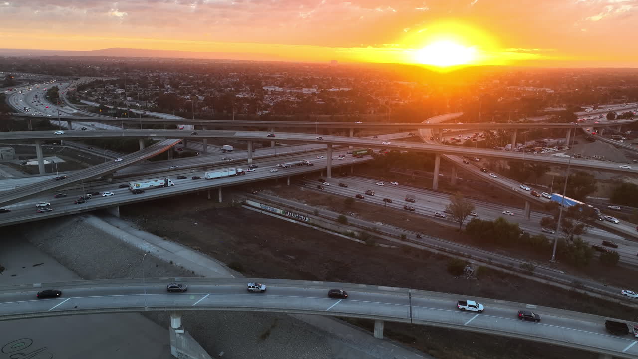 Aerial view of traffic on freeway overpasses in Los Angeles, sunny evening