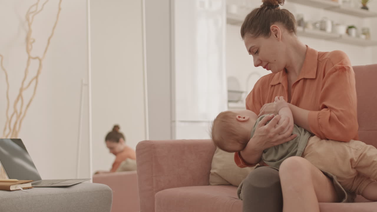 Woman with Disability Rocking Baby while Working from Home