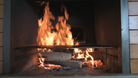 a fire burning in a stone furnace filmed