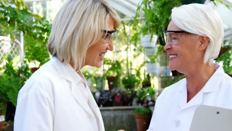 Happy-female-scientists-shaking-hands