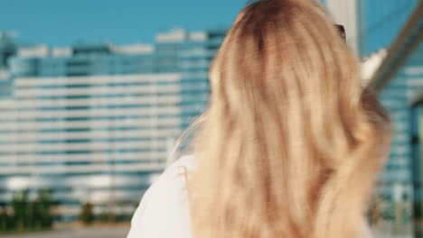 blonde woman walking in the city