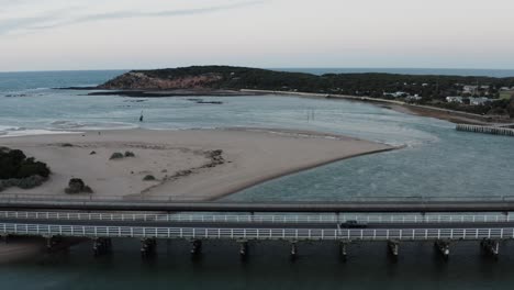 AERIAL-Trucking-Shot-Beside-Barwon-Heads-Bridge,-Victoria-Australia