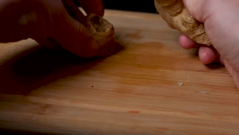 Cutting-a-ginger-tuber-on-a-wooden-cutting-board