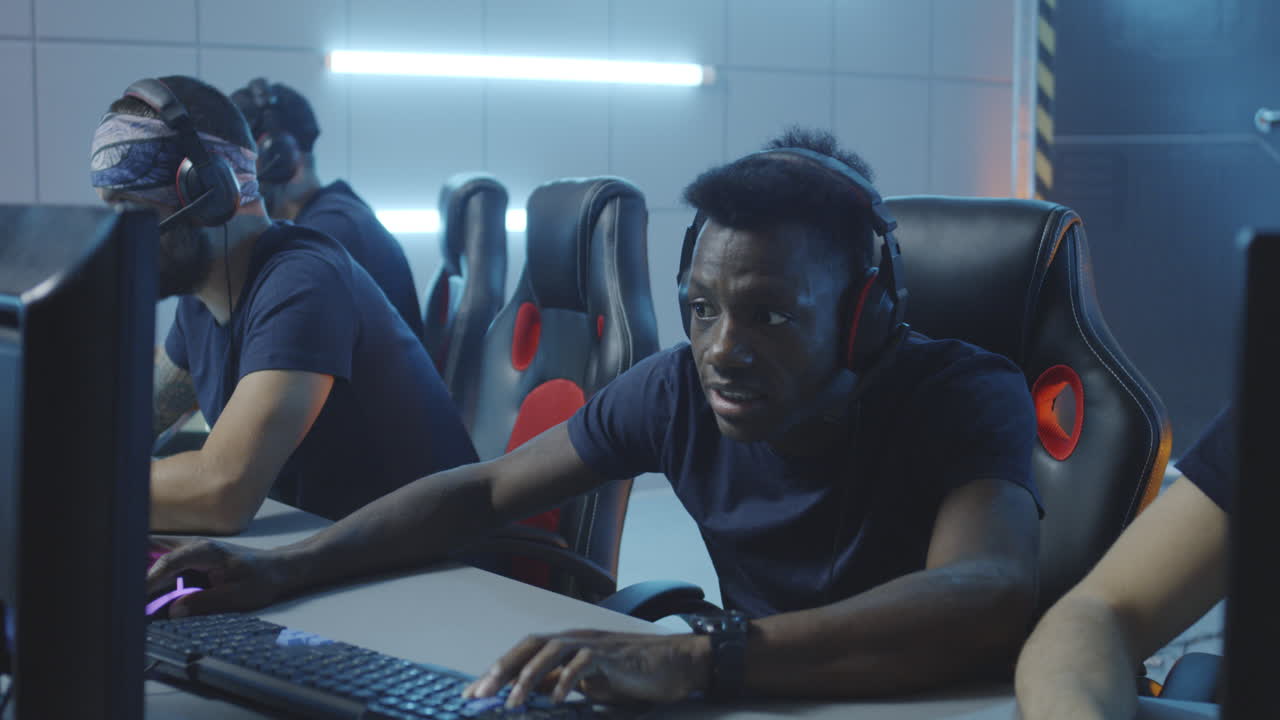 Young men playing computer games in an esports arena