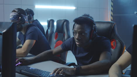 young men playing computer games in an esports arena